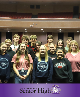  GISH All-State musicians smiling on stage in the GISH Auditorium. 